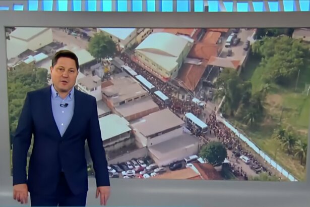 Eleandro Passaia em frente ao telão do Balanço Geral que mostra soltura do MC Poze do Rodo