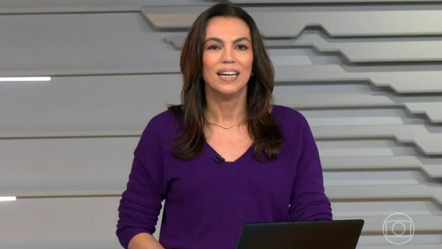 Ana Paula Araújo, vestindo uma blusa roxa, na bancada do Bom Dia Brasil