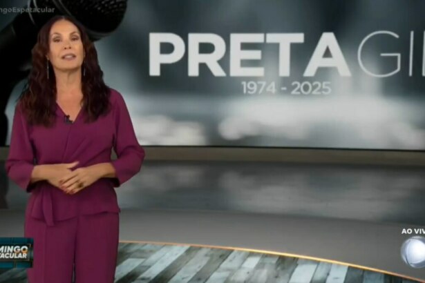 Carolina Ferraz, com uma roupa em tom vinho, emocionada na cobertura da morte de Preta Gil no Domingo Espetacular