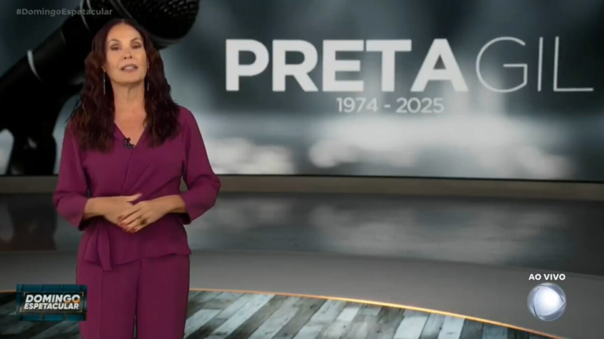 Carolina Ferraz, com uma roupa em tom vinho, emocionada na cobertura da morte de Preta Gil no Domingo Espetacular