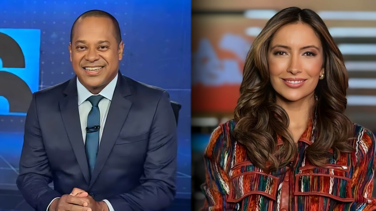 Luiz Fara Monteiro sentado na bancada do Jornal da Record, dividindo tela com Paloma Poeta no cenário do Fala Brasil. Ambos estão sorridentes