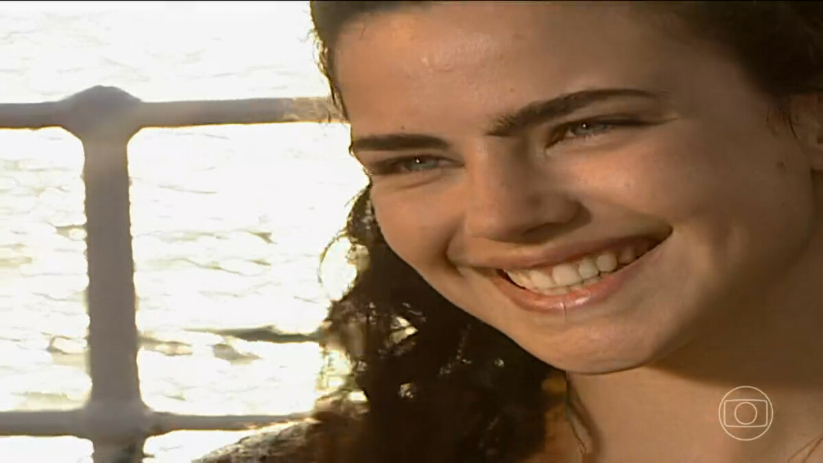 Foco no rosto de Giuliana sorrindo no primeiro capítulo de Terra Nostra