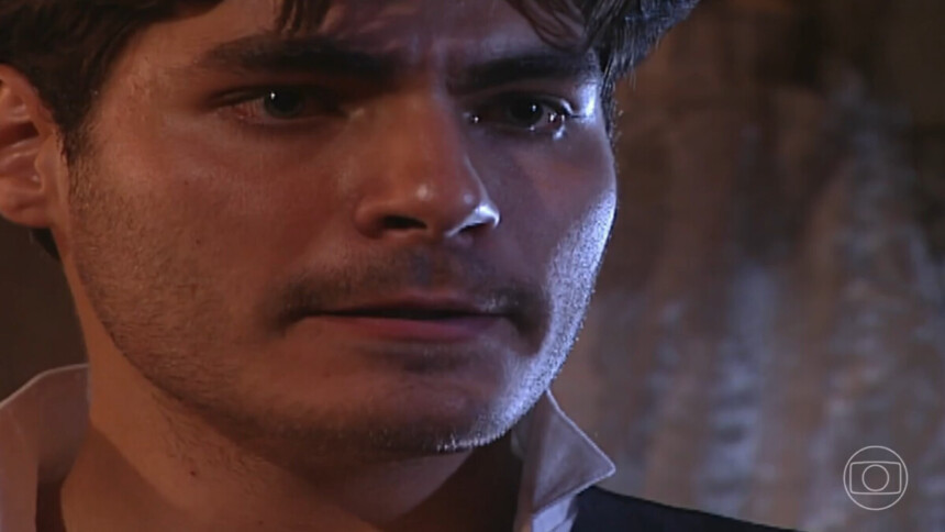 O ator Thiago Lacerda interpreta o personagem Matteo na novela Terra Nostra, com um close em seu rosto. Ele usa uma camisa branca de gola larga, tem um bigode fino e uma expressão séria e triste, com lágrimas nos olhos.